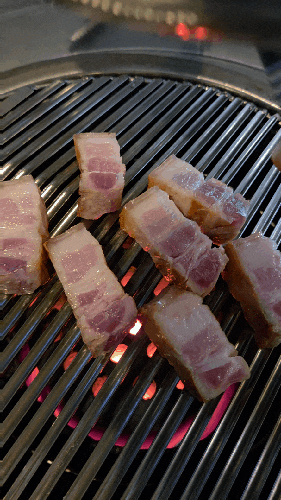 Korean pork belly or pork belly is being grilled deliciously on a grill(samgyeopsal and ogyeopsal.)